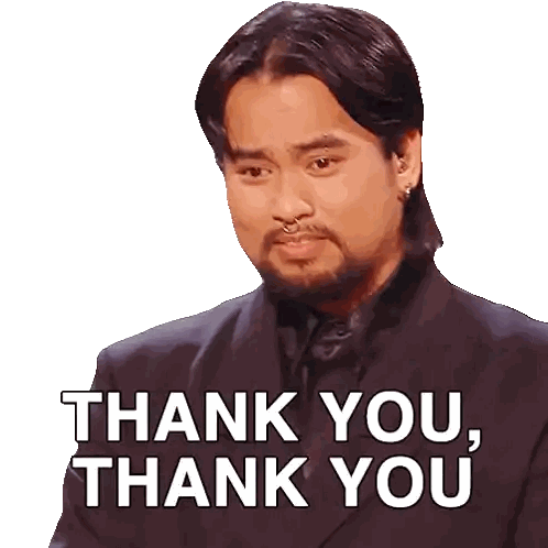 a man with a beard is wearing a black suit and says thank you