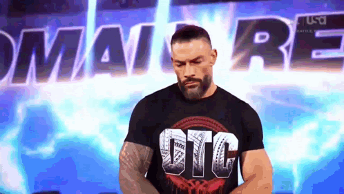 A Man With A Beard Is Wearing A Black T-Shirt That Says Gtc . GIF