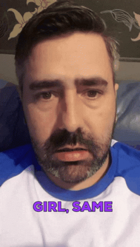 A Man With A Beard Is Wearing A Blue And White Shirt With The Words Girl Same On It GIF
