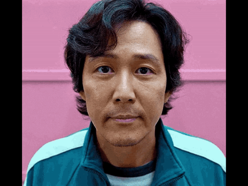 A Man With A Beard Is Wearing A Blue Jacket GIF