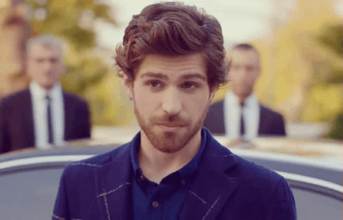 A Man With A Beard Is Wearing A Blue Jacket And A Blue Shirt GIF