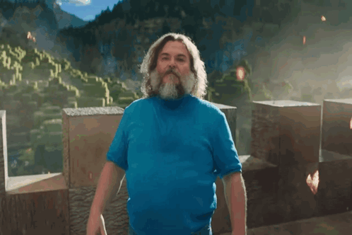 A Man With A Beard Is Wearing A Blue Shirt And Has The Letter I On His Chest GIF