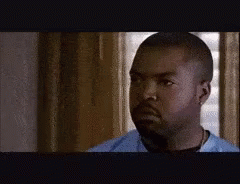 A Man With A Beard Is Wearing A Blue Shirt . GIF