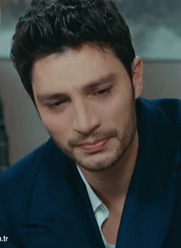 A Man With A Beard Is Wearing A Blue Suit And White Shirt GIF
