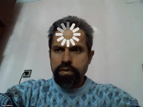 A Man With A Beard Is Wearing A Blue Sweater And Has A Spinning Wheel On His Head GIF