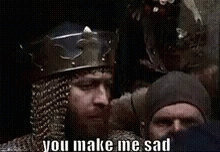 A Man With A Beard Is Wearing A Crown And A Helmet And Says You Make Me Sad . GIF
