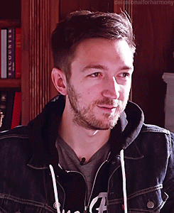 A Man With A Beard Is Wearing A Denim Jacket And A Hoodie GIF