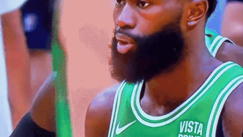 A Man With A Beard Is Wearing A Green Jersey That Says Vista On It GIF