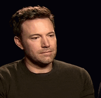 A Man With A Beard Is Wearing A Green Shirt GIF
