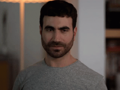 A Man With A Beard Is Wearing A Grey T-Shirt GIF