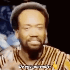 a man with a beard is wearing a hat and a striped shirt and is saying `` do you remember '' .