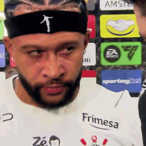 a man with a beard is wearing a headband and a shirt that says frimesa