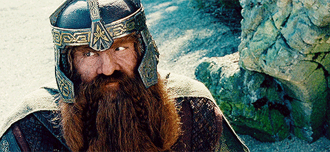A Man With A Beard Is Wearing A Helmet With The Letter X On It GIF