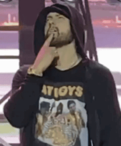 A Man With A Beard Is Wearing A Hoodie And A T-Shirt That Says ' Atioys ' . GIF
