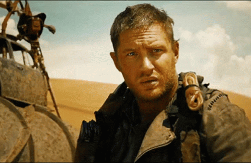 A Man With A Beard Is Wearing A Jacket That Says ' G ' On It GIF