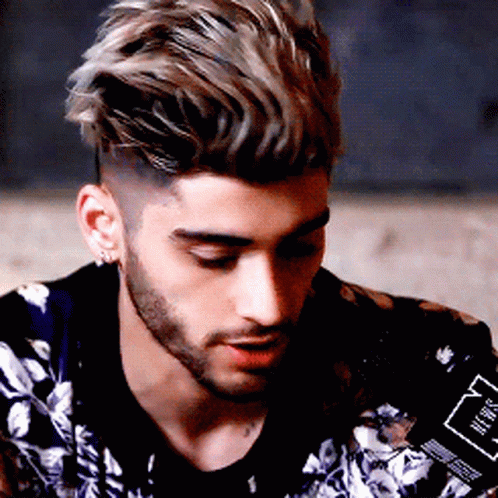 A Man With A Beard Is Wearing A Jacket With A Floral Pattern GIF