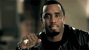 A Man With A Beard Is Wearing A Leather Jacket And Holding A Ring In His Hand . GIF