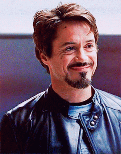 A Man With A Beard Is Wearing A Leather Jacket GIF