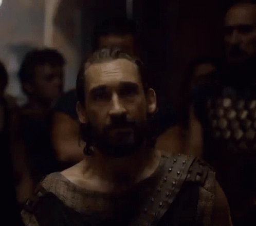 A Man With A Beard Is Wearing A Leather Vest GIF