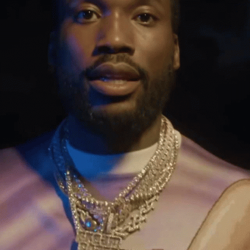 A Man With A Beard Is Wearing A Necklace That Says Ice Cube GIF