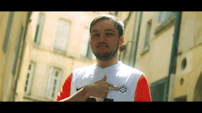 A Man With A Beard Is Wearing A Nike Shirt And Pointing To His Chest GIF