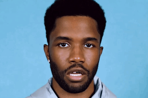 A Man With A Beard Is Wearing A Pair Of Earrings GIF