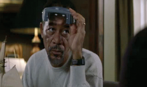 A Man With A Beard Is Wearing A Pair Of Glasses On His Head . GIF