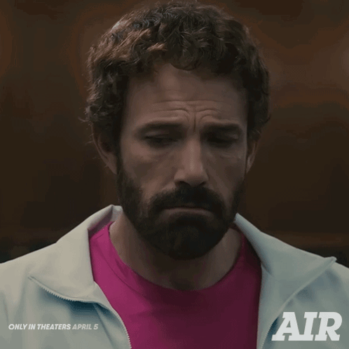 A Man With A Beard Is Wearing A Pink Shirt And A White Jacket That Says " Air " GIF