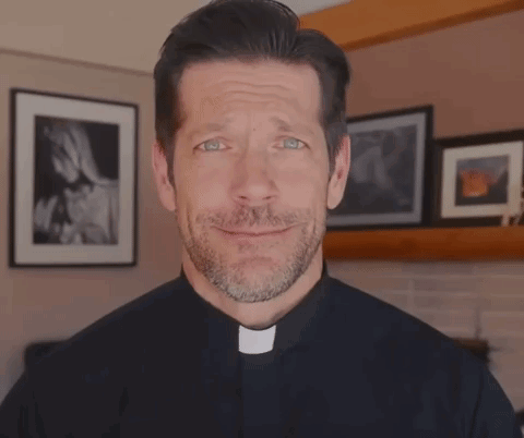 A Man With A Beard Is Wearing A Priest Collar And Making A Funny Face GIF