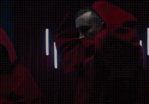 A Man With A Beard Is Wearing A Red Cape With A Hood GIF