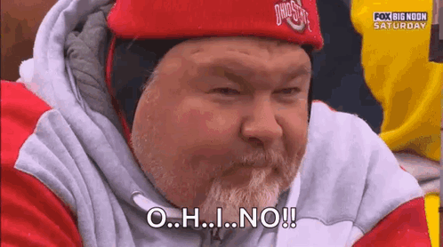 A Man With A Beard Is Wearing A Red Hat And A Sweatshirt And Says O.h.i. No ! GIF
