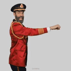 A Man With A Beard Is Wearing A Red Jacket And Hat And Is Dancing . GIF