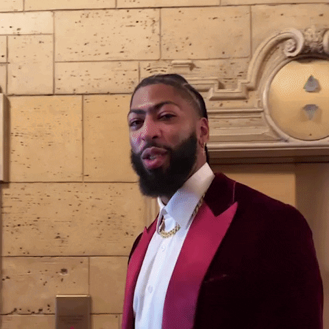 A Man With A Beard Is Wearing A Red Jacket And White Shirt GIF