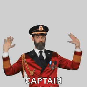 A Man With A Beard Is Wearing A Red Military Uniform And Making A Captain Gesture . GIF