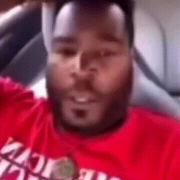 A Man With A Beard Is Wearing A Red T-Shirt That Says ' Miami ' On It . GIF