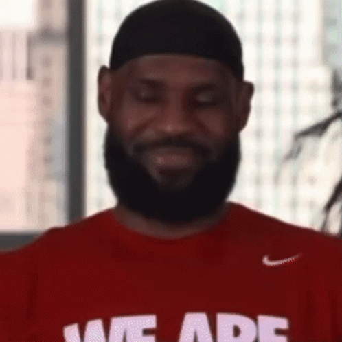 A Man With A Beard Is Wearing A Red T-Shirt That Says We Are . GIF