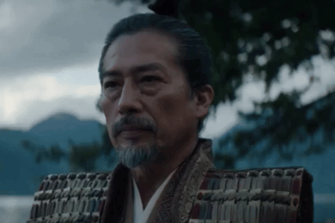 a man with a beard is wearing a samurai costume and armor .