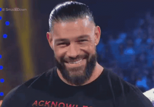 A Man With A Beard Is Wearing A Shirt That Says Acknowledgment GIF