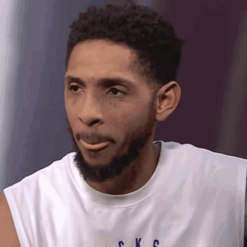 A Man With A Beard Is Wearing A Shirt That Says Ckc GIF