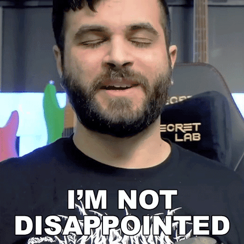A Man With A Beard Is Wearing A Shirt That Says I 'M Not Disappointed GIF