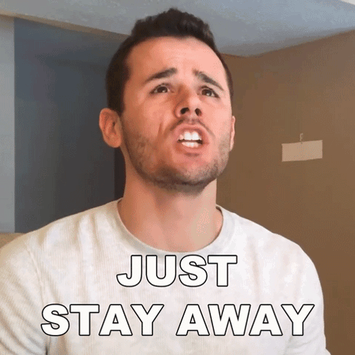 A Man With A Beard Is Wearing A Shirt That Says " Just Stay Away " GIF