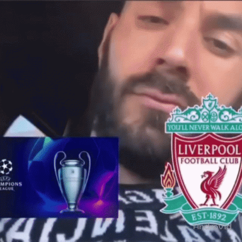 a man with a beard is wearing a shirt that says liverpool football club