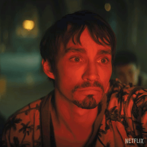 A Man With A Beard Is Wearing A Shirt That Says Netflix On The Bottom GIF