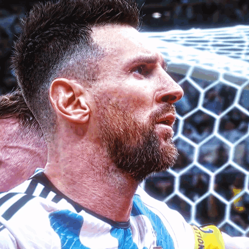 A Man With A Beard Is Wearing A Shirt That Says ' Soccer ' On It GIF
