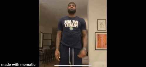 A Man With A Beard Is Wearing A Shirt That Says ' Yjima ' On It GIF