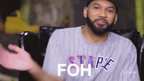 A Man With A Beard Is Wearing A Striped Shirt That Says ' Stape Foh ' On It . GIF