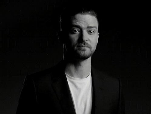 A Man With A Beard Is Wearing A Suit And A White Shirt GIF