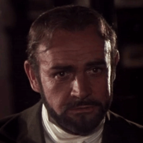 A Man With A Beard Is Wearing A Suit And White Shirt GIF