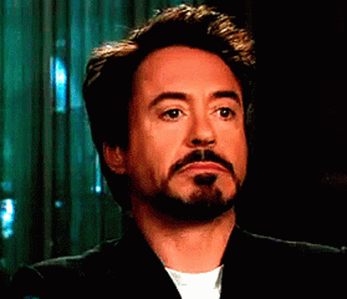 A Man With A Beard Is Wearing A Suit And White Shirt GIF