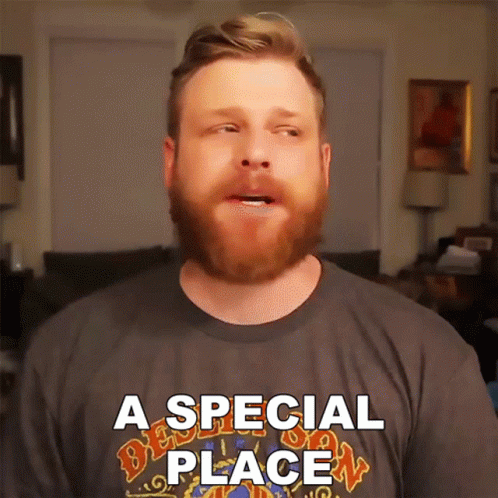 A Man With A Beard Is Wearing A T-Shirt That Says A Special Place GIF